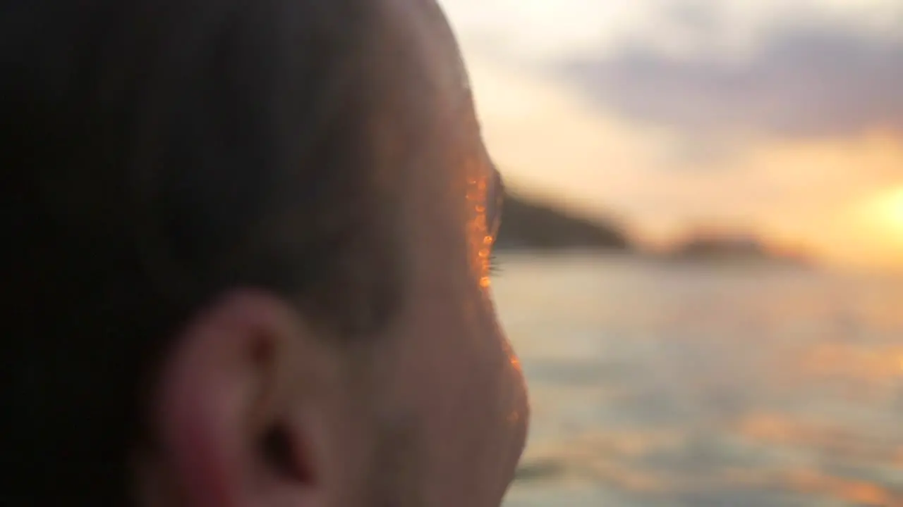 Man Smiling in the Sea at Sunset