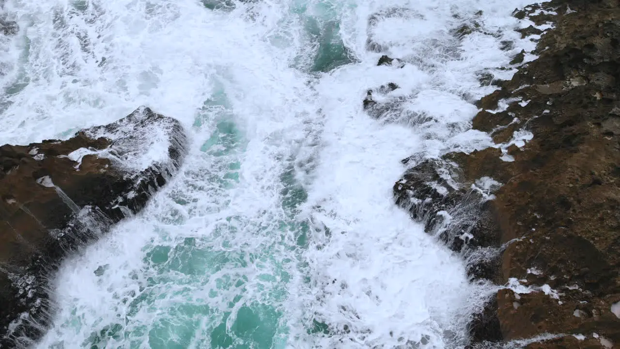 Waves Crashing in the ocean near some rocks closeup