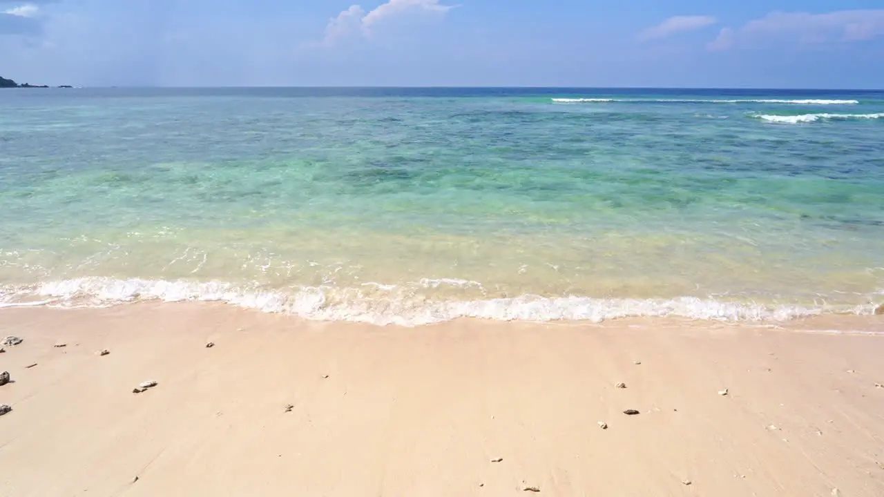 Tropical Paradise White Sand Beach Turquoise Sea and Blue Sky at Skyline Full Frame Static Shot