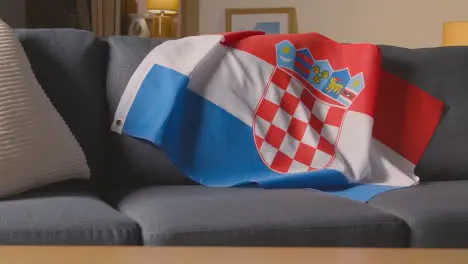 Flag Of Croatia Draped Over Sofa At Home Ready For Match On TV