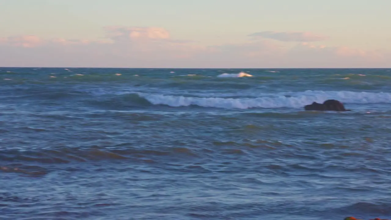 Waves and rocks panning left to right