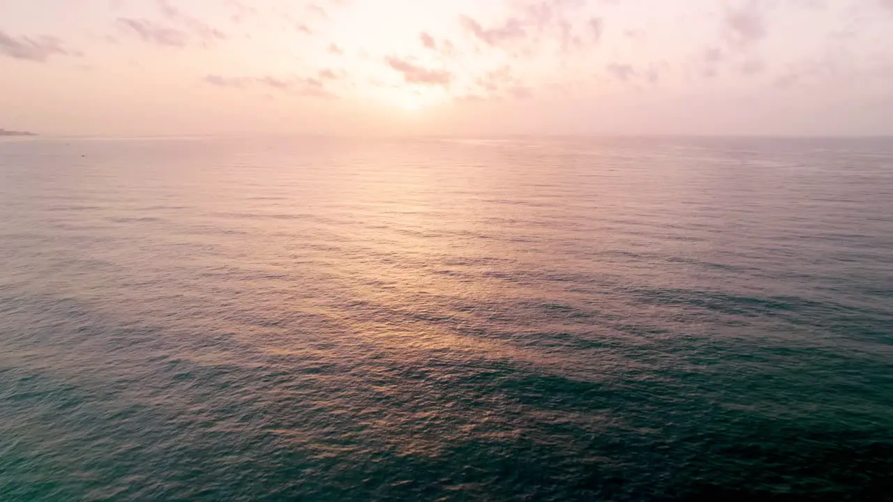 Aerial moving forward on the Mediterranean Sea birdseye view tilting up into the horizon