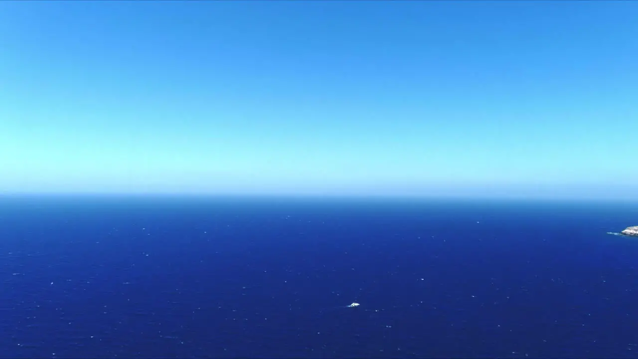 Aerial 4K Blue Sea and Sky Top View Over Akrotiri Santorini Greece Above Ship in Water