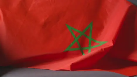 Close Up Of Flag Of Morocco Draped Over Sofa At Home Ready For Match On TV