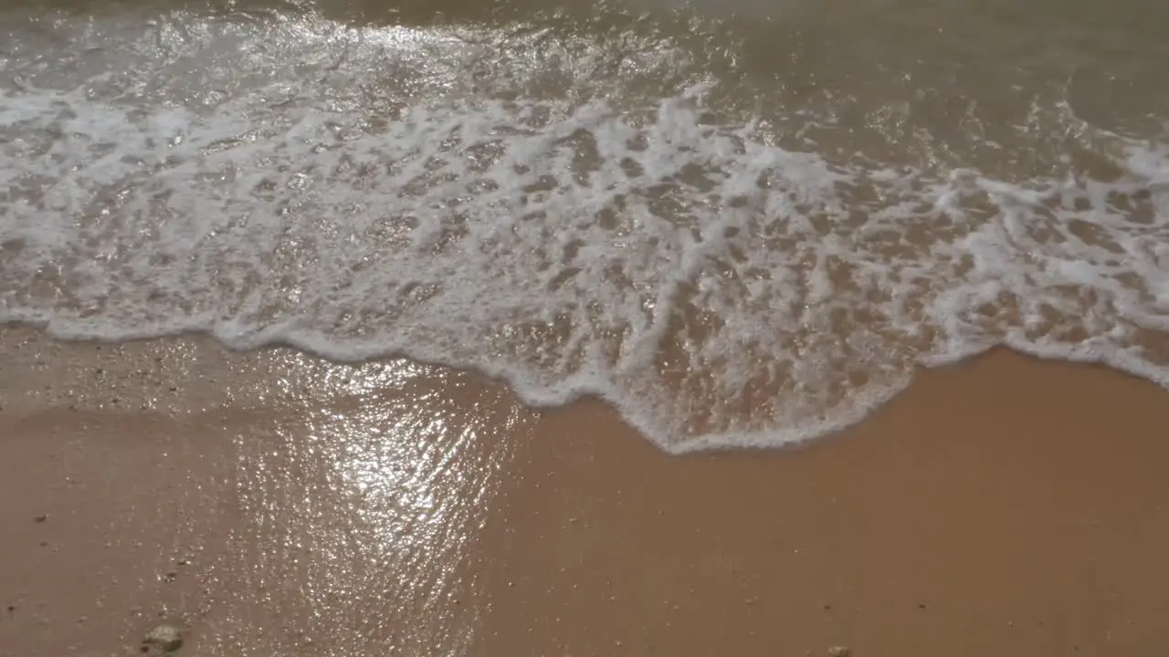 the beach with white sand and wave from peaceful sea in sunshine daytime