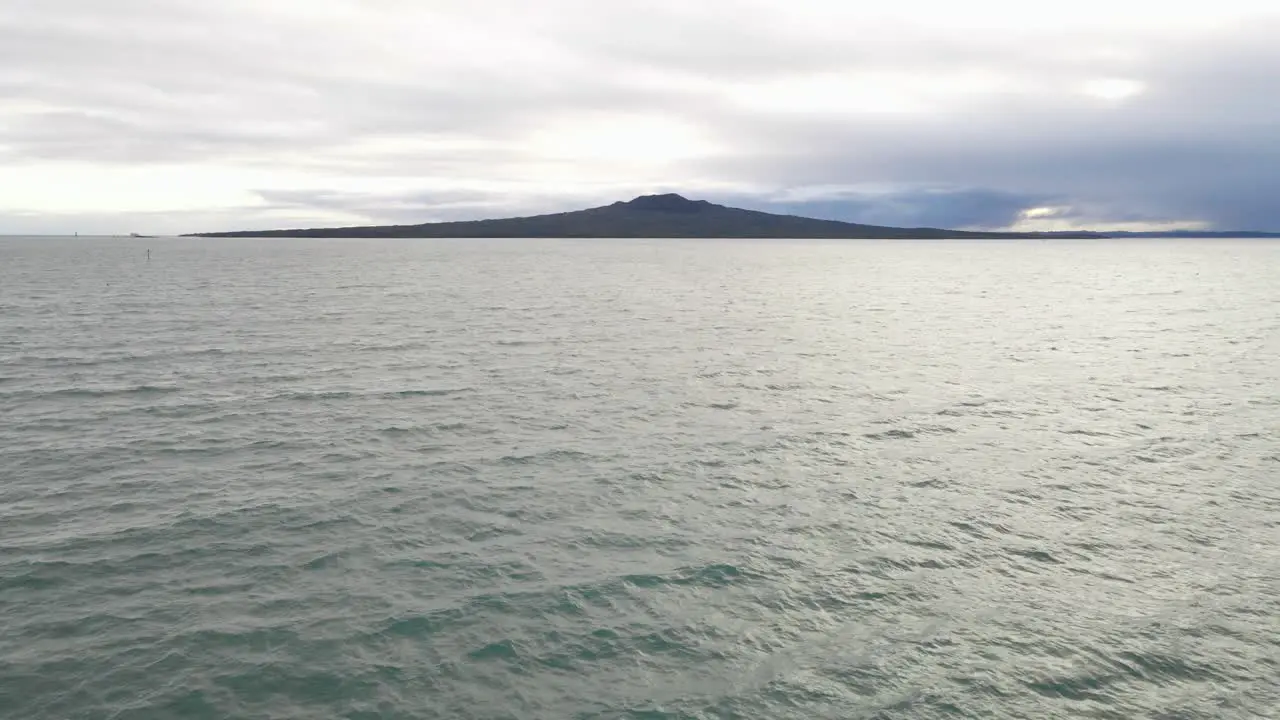 descending drone shot of the Rangitoto Island Volcano