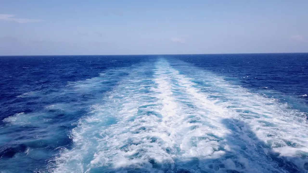 Amazing blue Caribbean Sea and wake of cruise ship sailing across the ocean