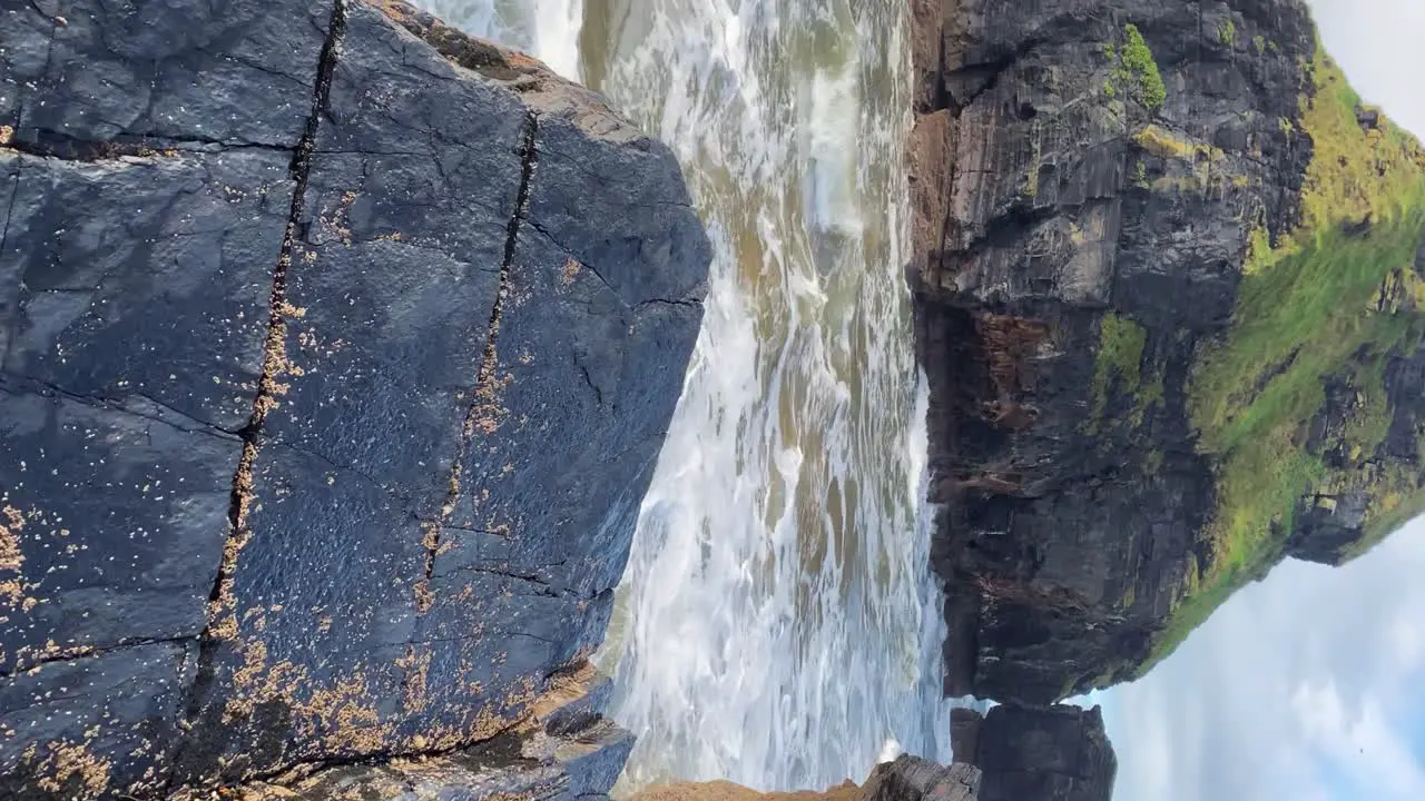 Vertical POV walking along rough Irish Atlantic coastline