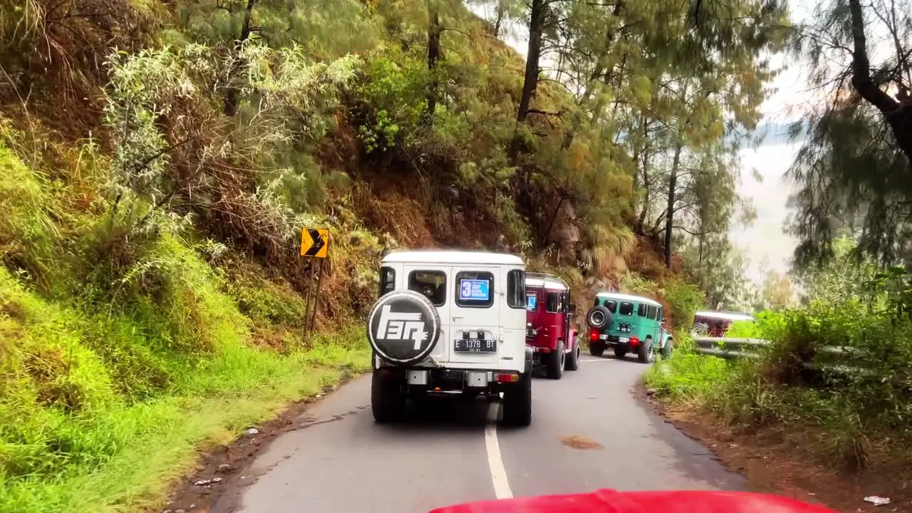 Jeep 4X4 Car driving on the road in the middle of forest