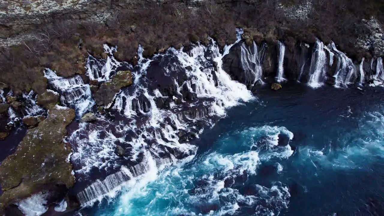 Famous waterfall cascade Hraunfossar in Iceland aerial orbit