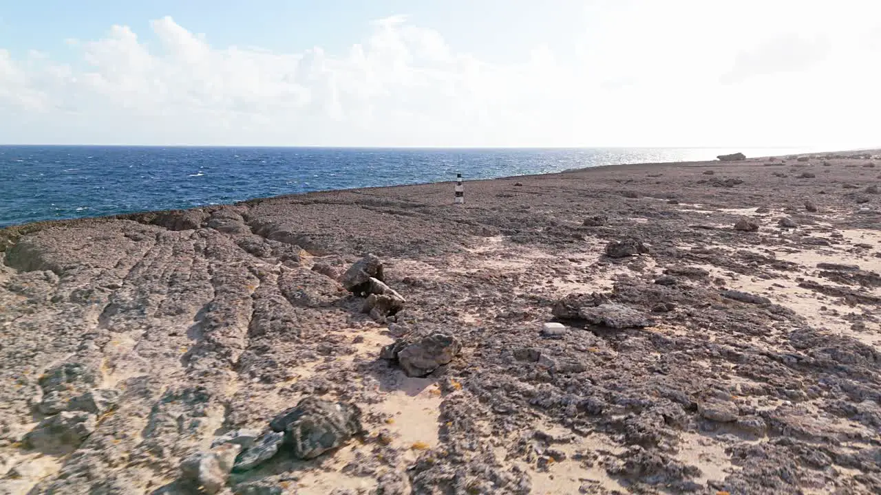 Aerial orbit along sand on rocky tendrils of Northside Curacao