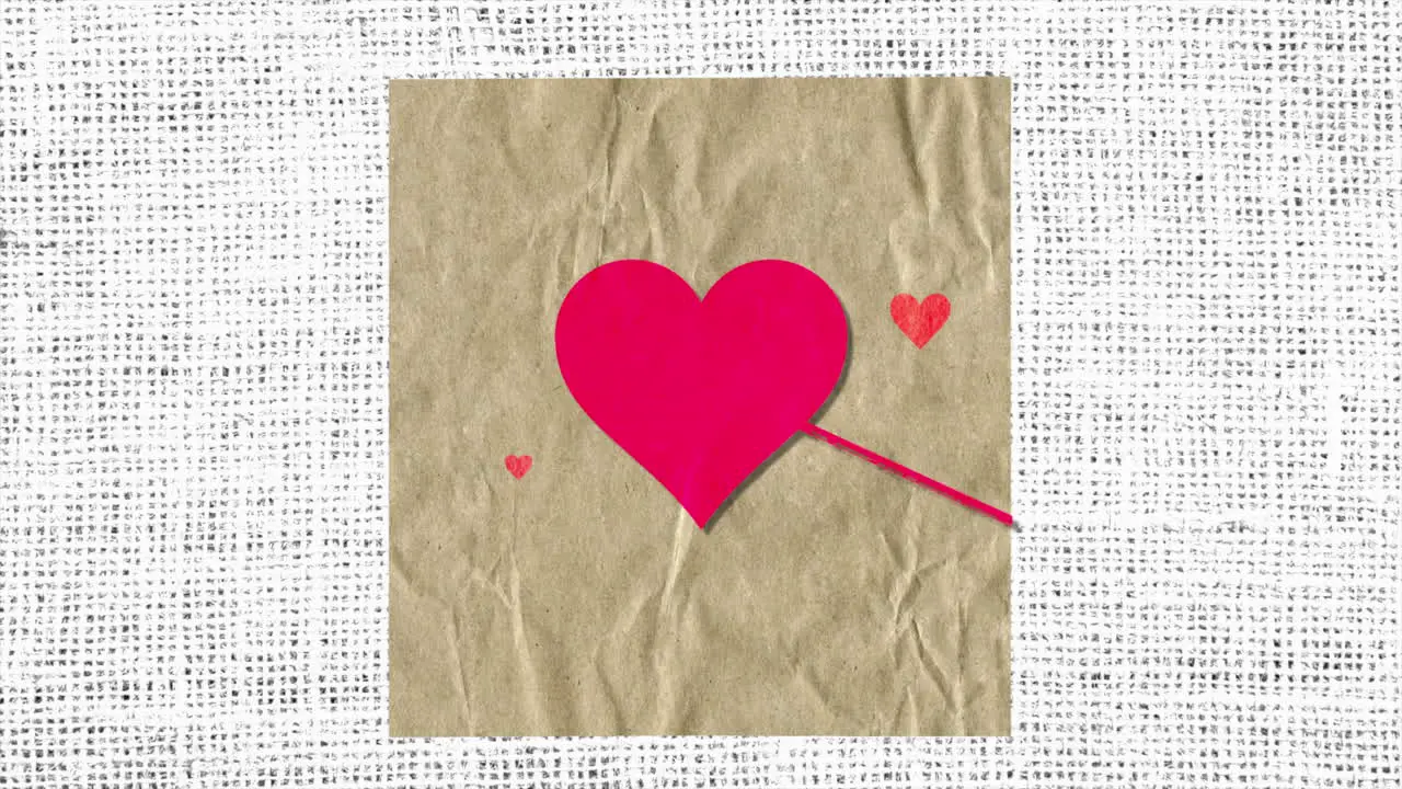 Red hearts with arrow on paper with textile