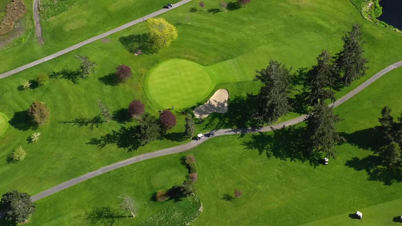 Aerial of golfers going out onto the green to putt