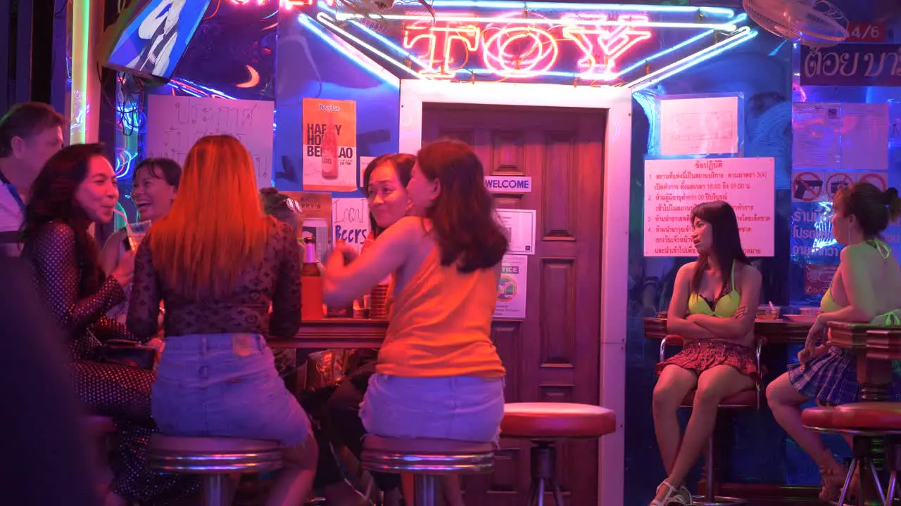 Bar girls in Soi Cowboy sitting outside the Toy Bar waiting for customers