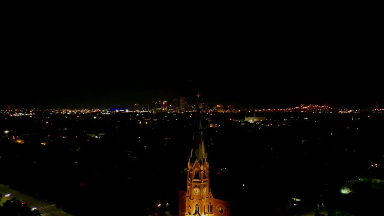 Droning past a large steeple towards the city of New Orleans