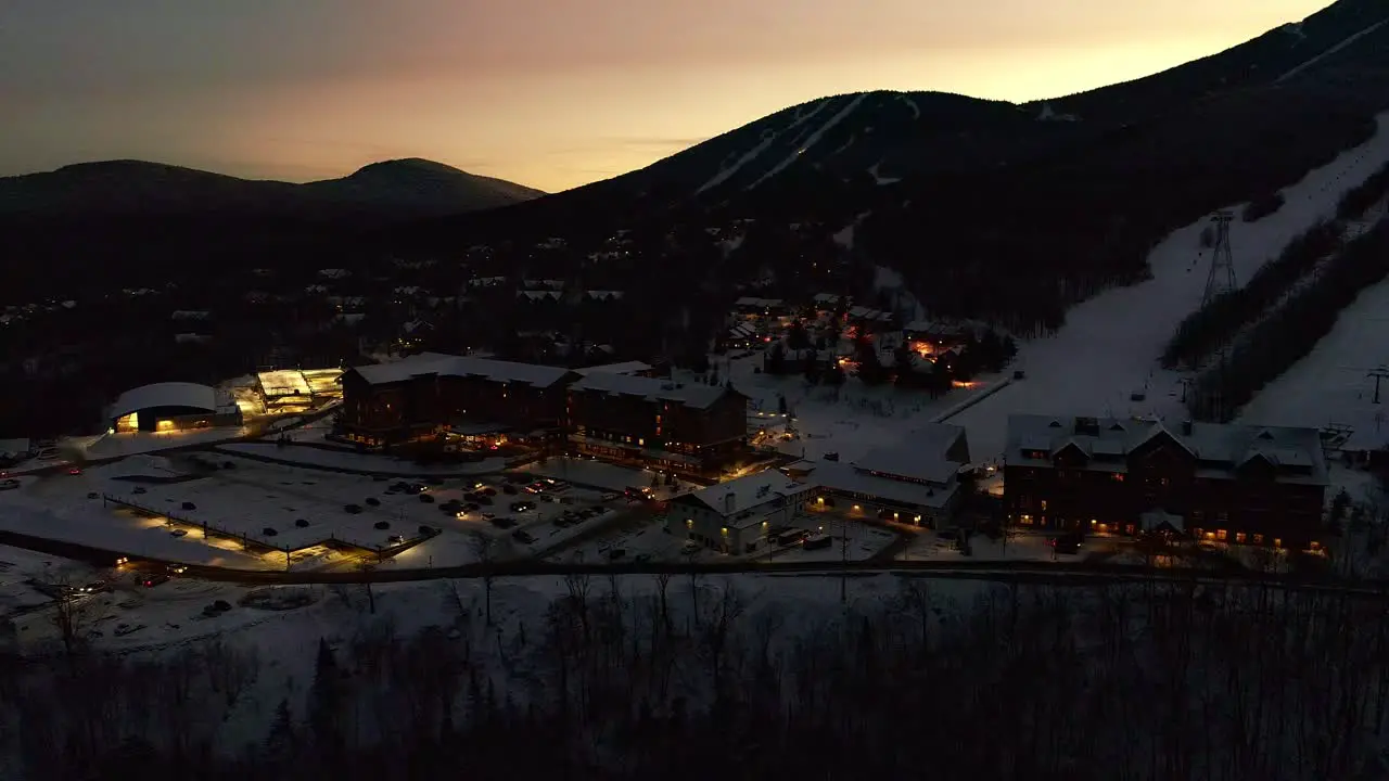 Golden sunset over a ski mountain and resort- Drone video