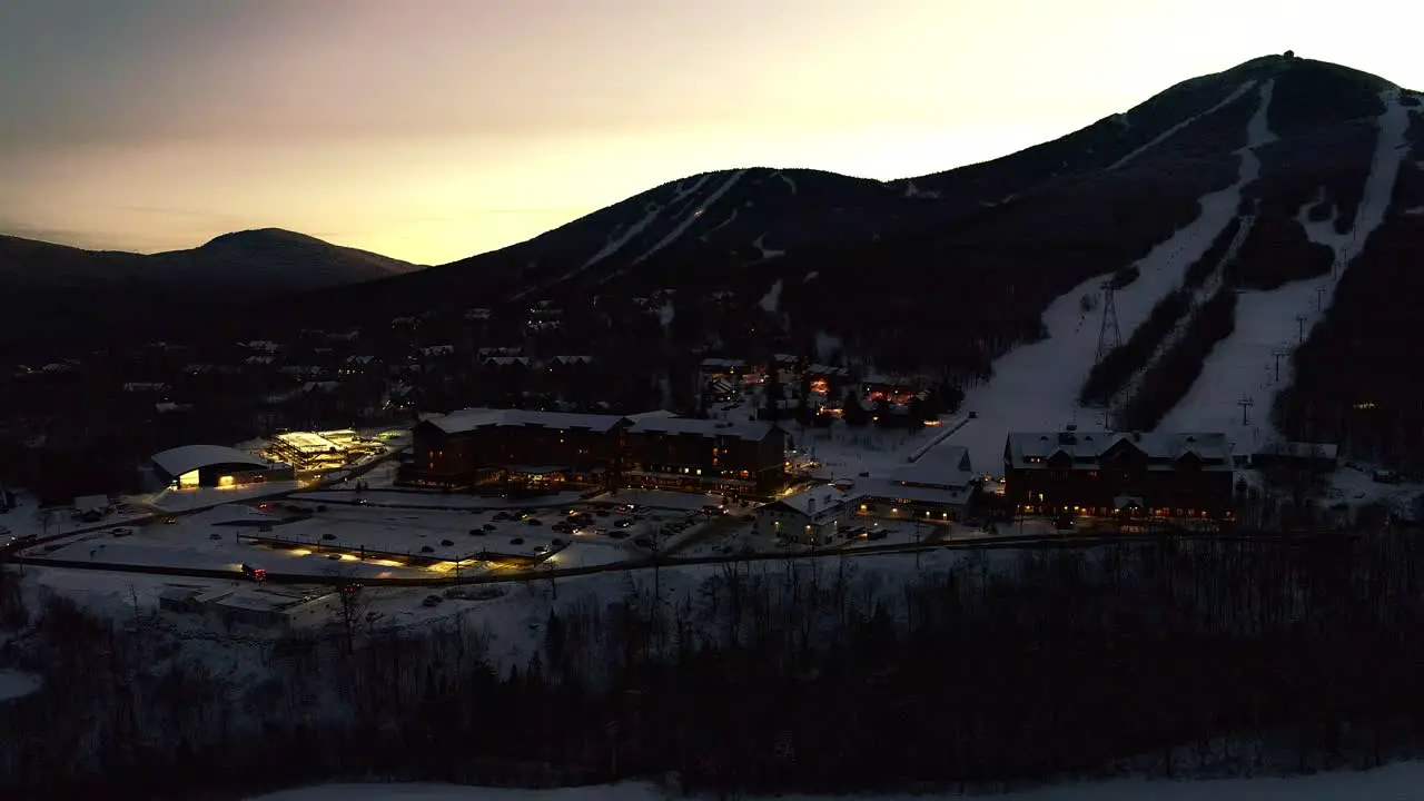 People coming out of lodge at a ski resort- drone video