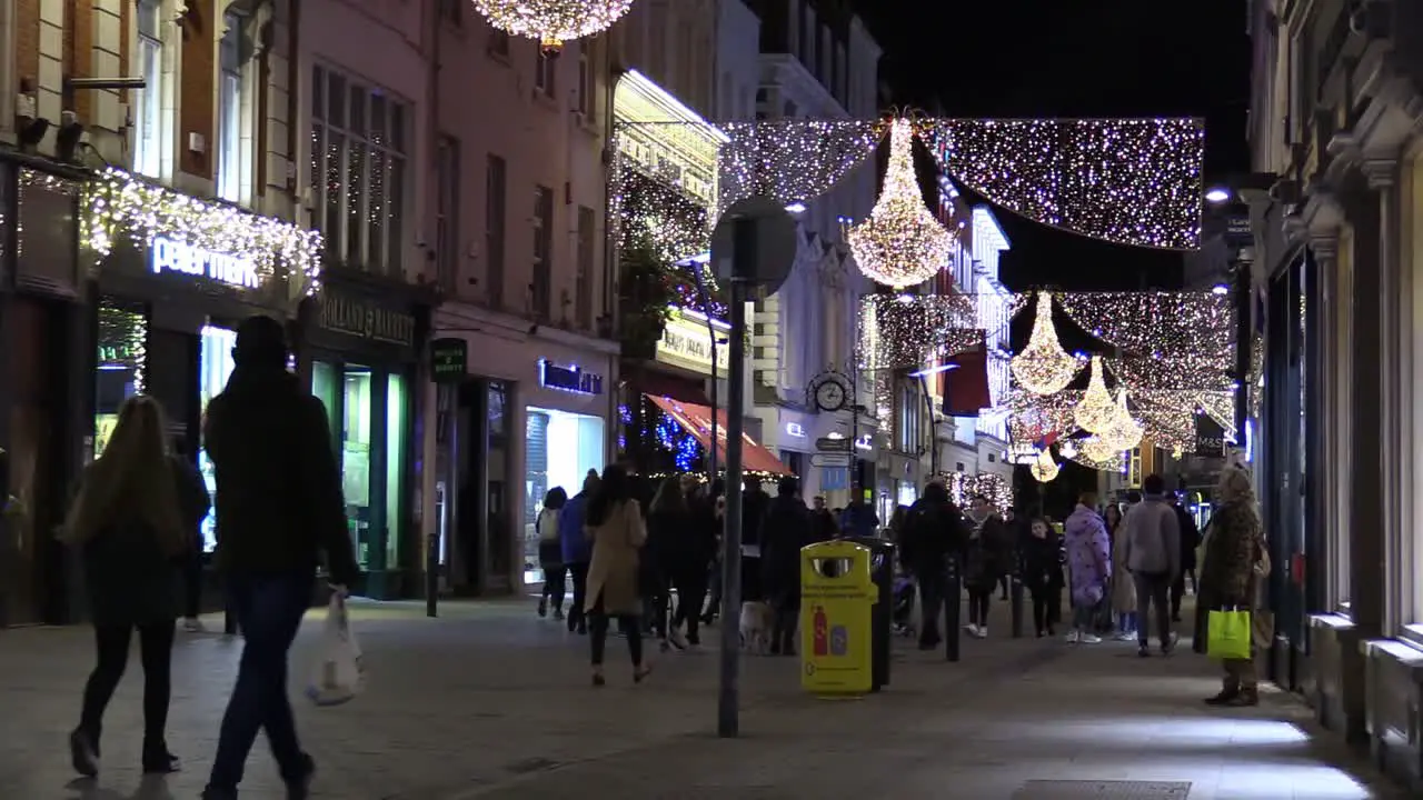 Still shot of a Dublin street at Chrismas time in hard times with some people on a not so busy street