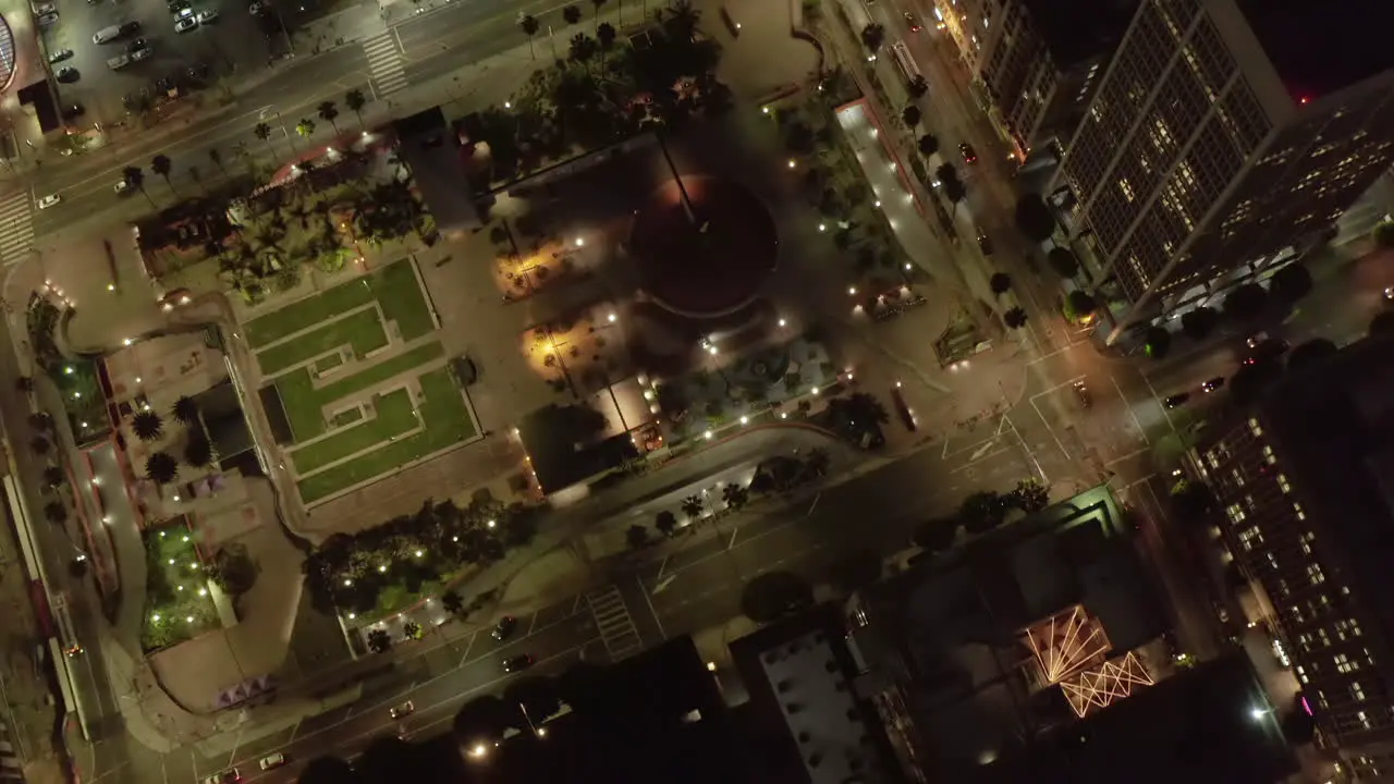 Pershing square in Downtown Los Angeles California at Night with lit up glowing city street lights Aerial Birds Eye Overhead Top Down View