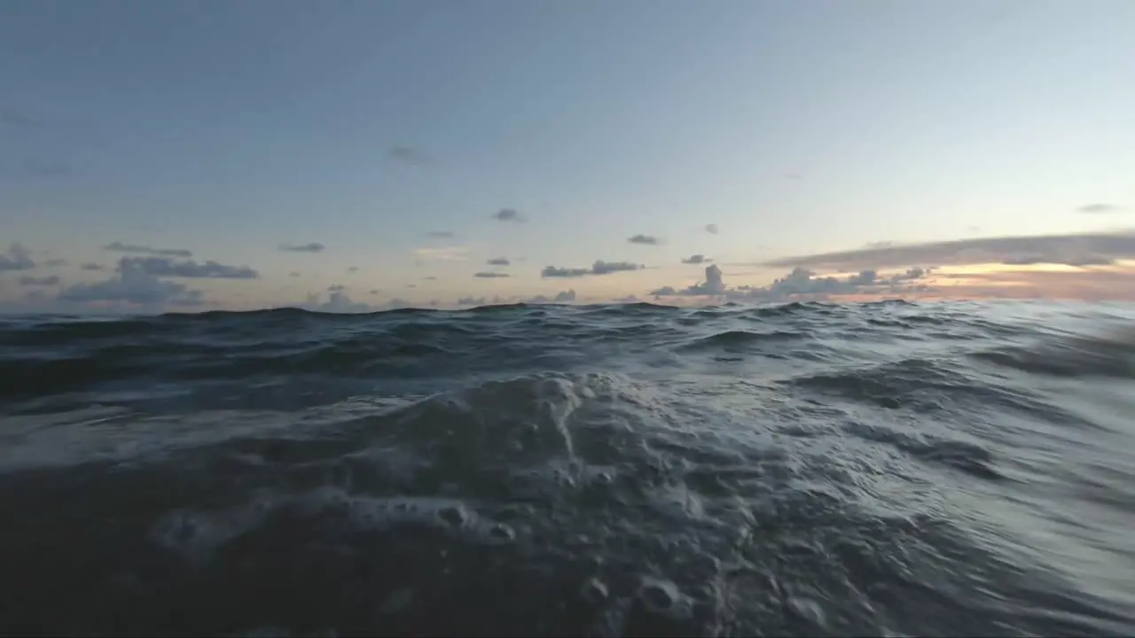 Floating on a calm beach at sunset in the summer First person view gopro camera