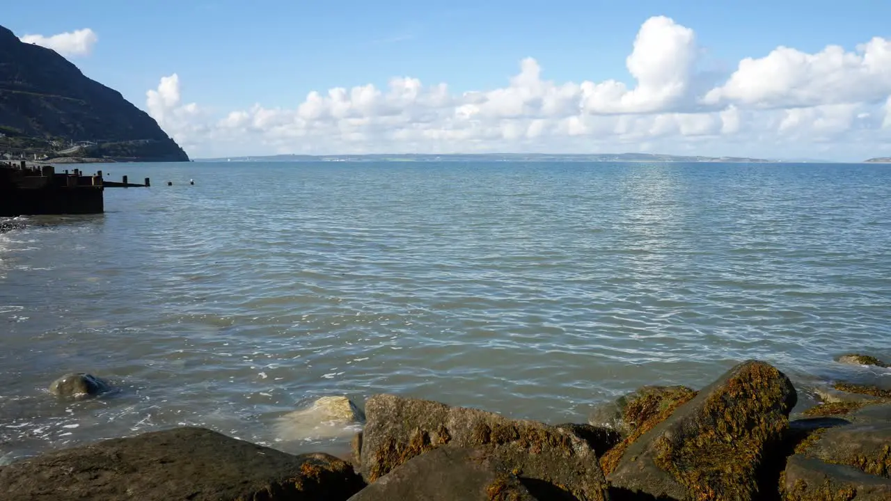 Relaxing blue ocean stone pebble beach coastline island holiday scene