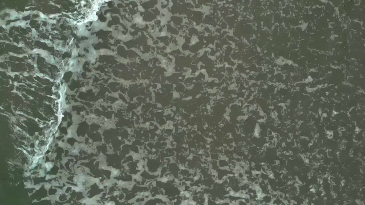 Aerial top shot of waves on Baltic Sea in slow motion