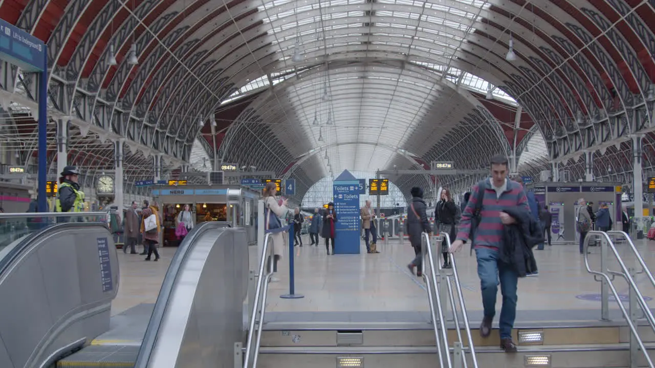 Man walking down stairs from train station concourse