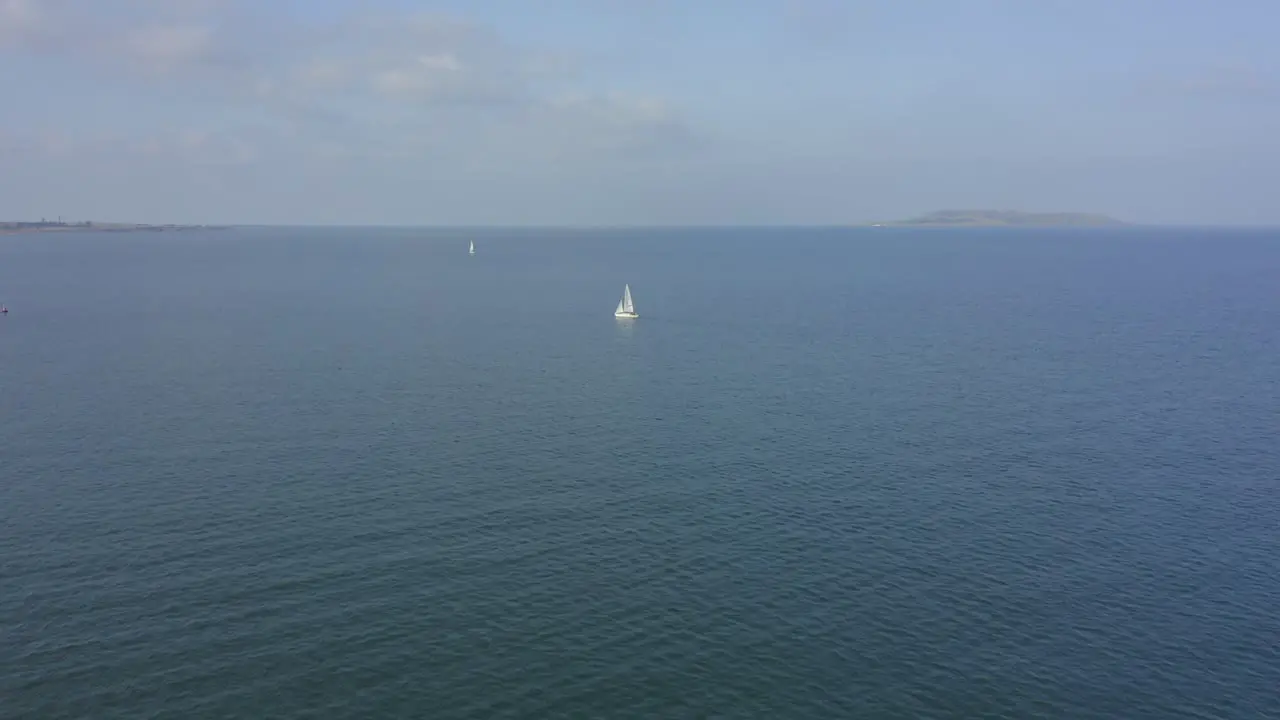 Aerial view 4K approaching shot two sail boats out at sea