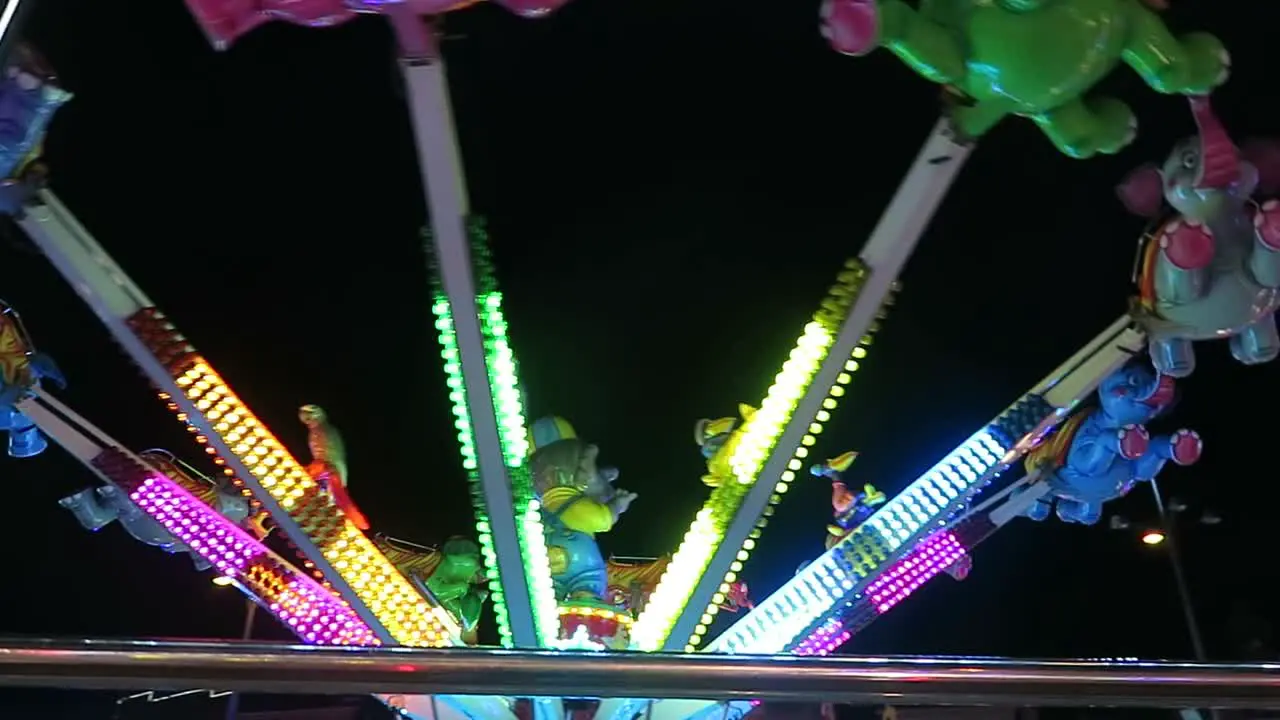 A children's ride at a amusement fair at night