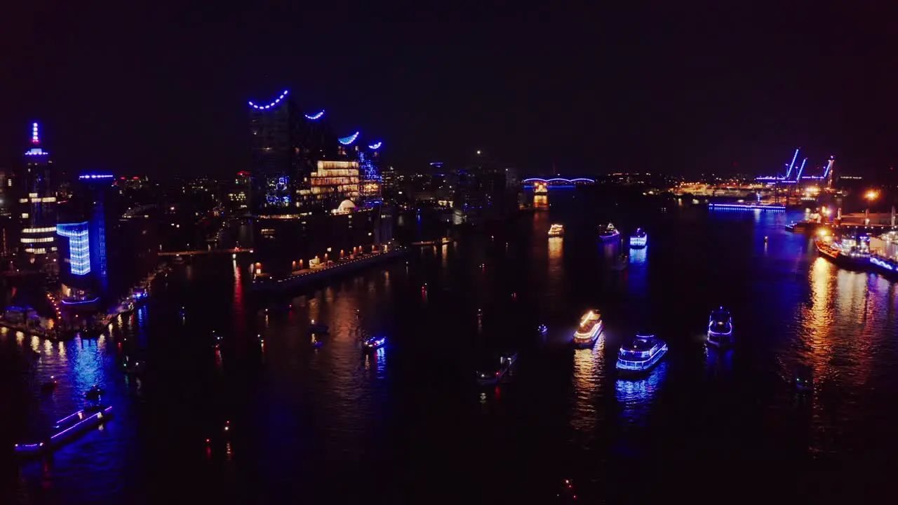 Drone Shot Hamburg Harbour light show during Cruise Days with blue lights across the city boats and Elbphilharmonie