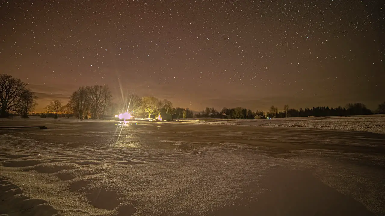 Local rural village of starry night sky glowing above fusion time lapse