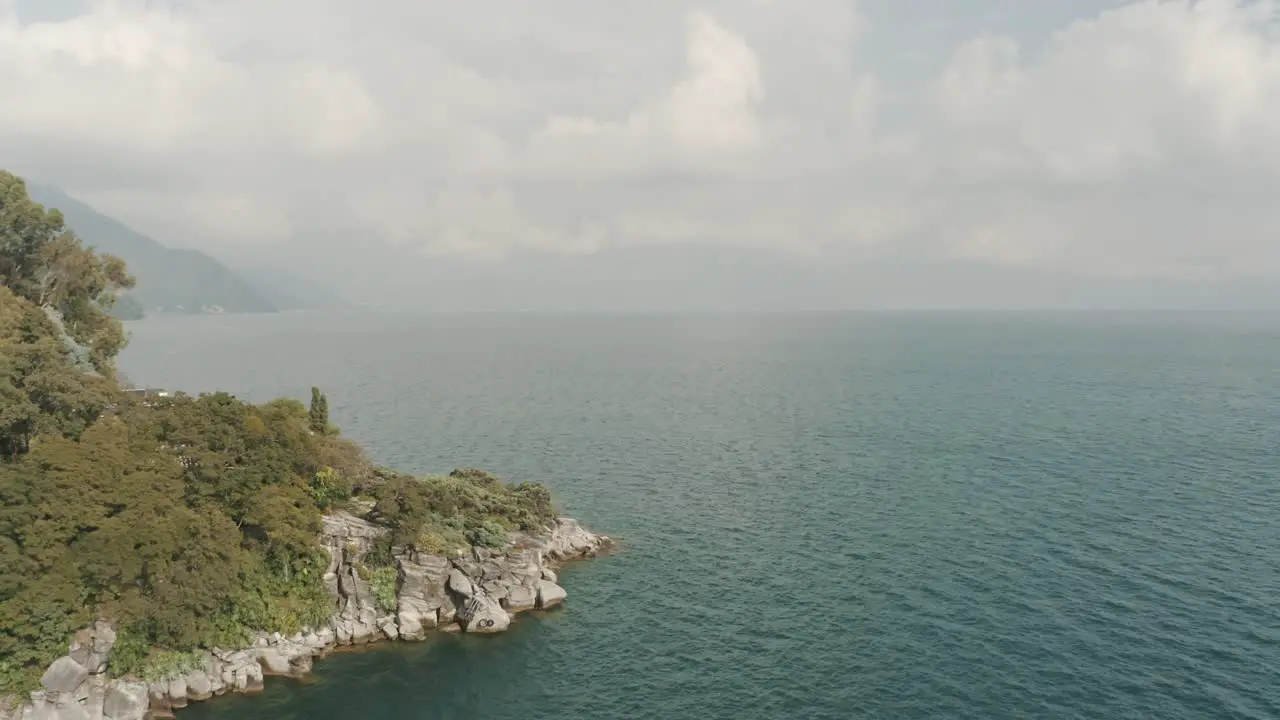 Drone aerial rotating around the bay of Tzununa Lake Atitlan Guatemala