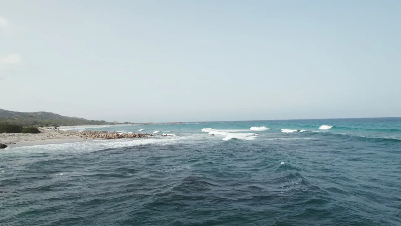 Aerial view drone over beach sea and rock coast with powerful sea waves