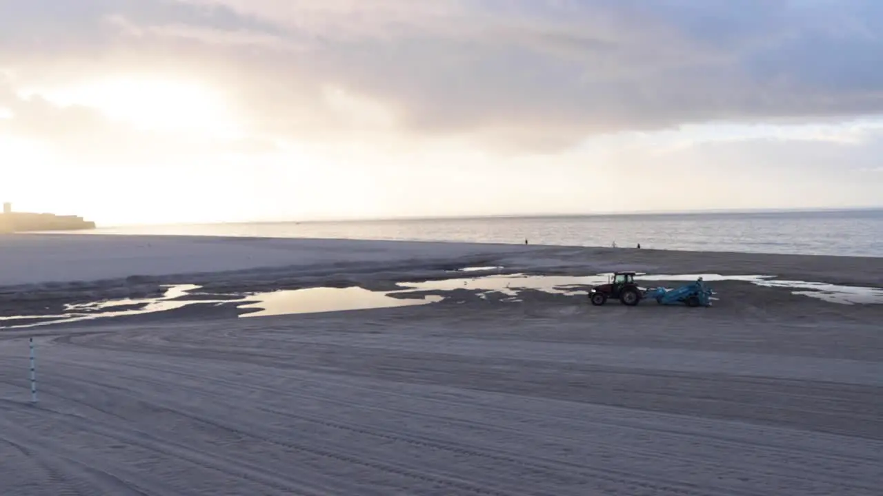 the trator walking at desert beach with a great sunrise