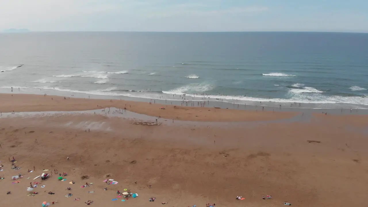 Aerial drone flying above vast beach sand coastline of Sopelana