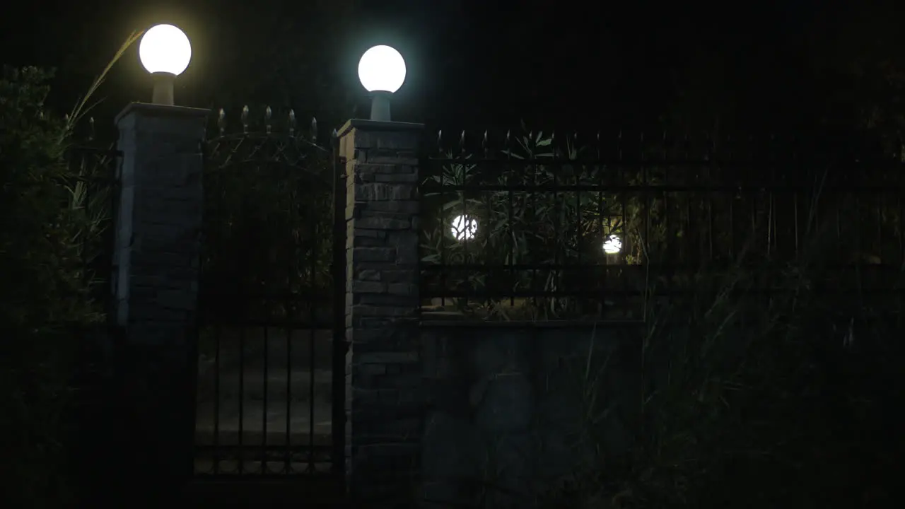 View on illuminated gates made of stone and metal