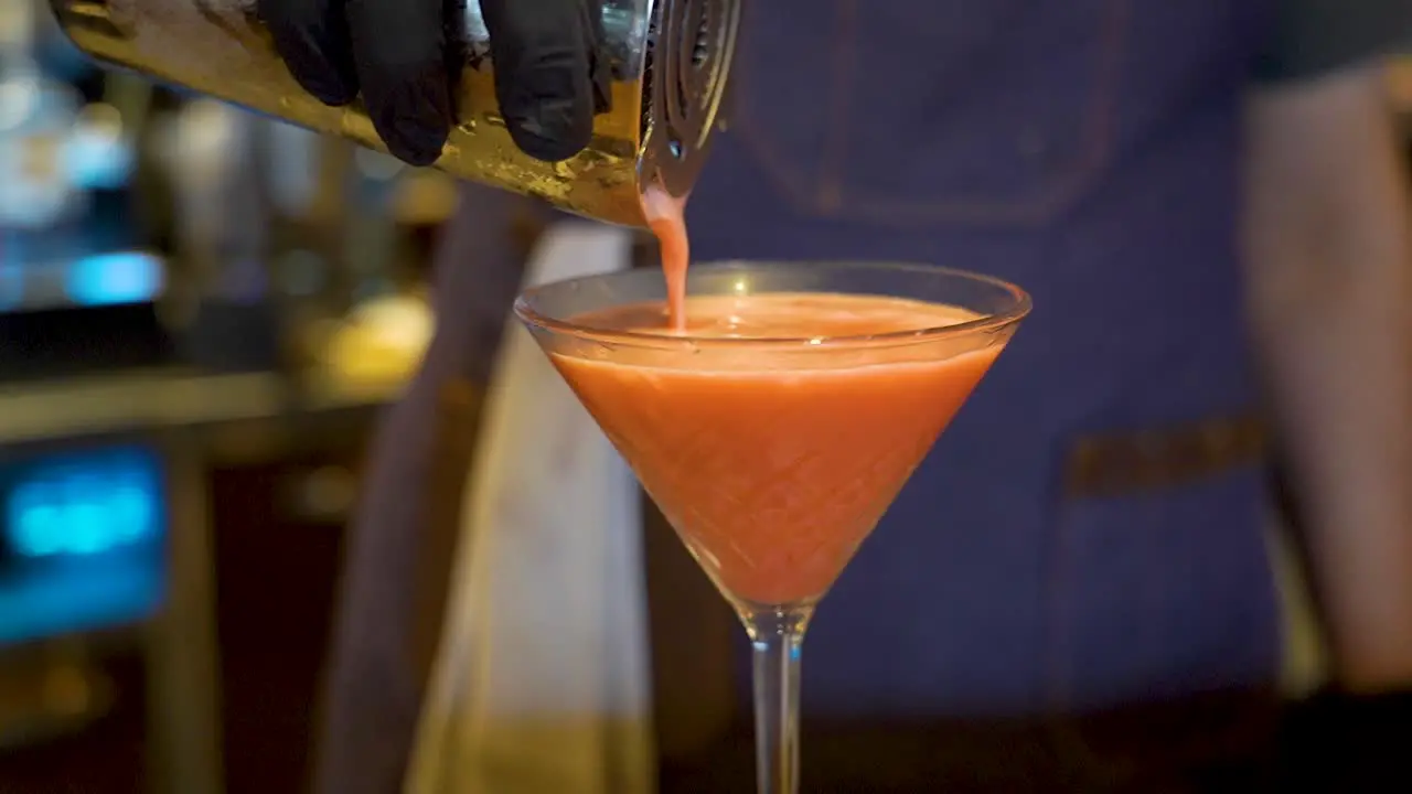 Pouring alcoholic orange drink in a bar