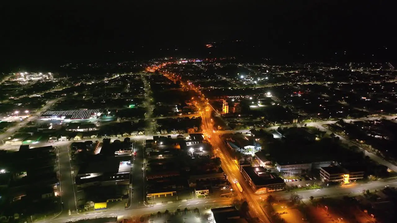 Drone flyover main street in Timaru town in the night