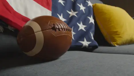 Lounge At Home Of Person Watching American Football Game On TV With Stars And Stripes Flag And Ball 1