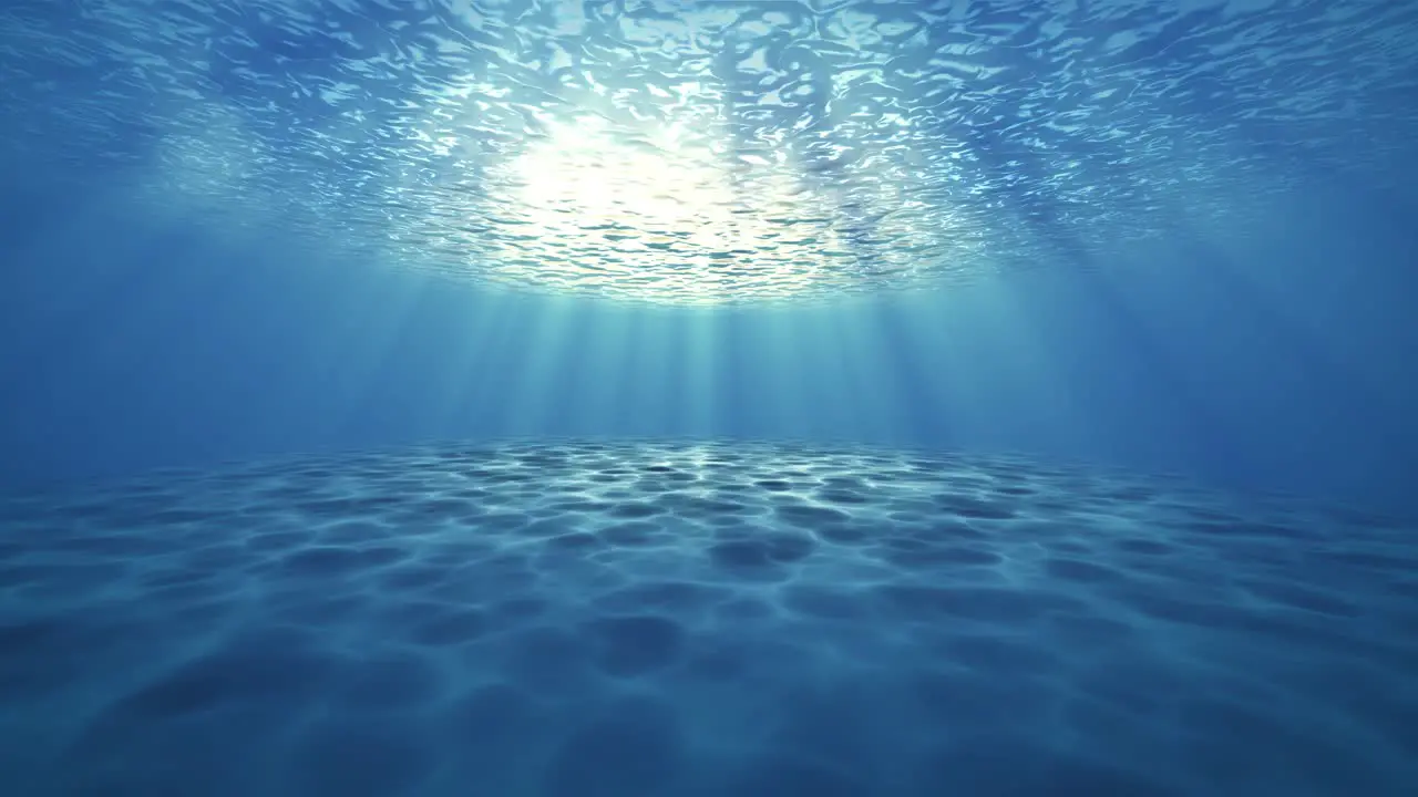 Blue ocean bottom with bubbles and light rays deep underwater