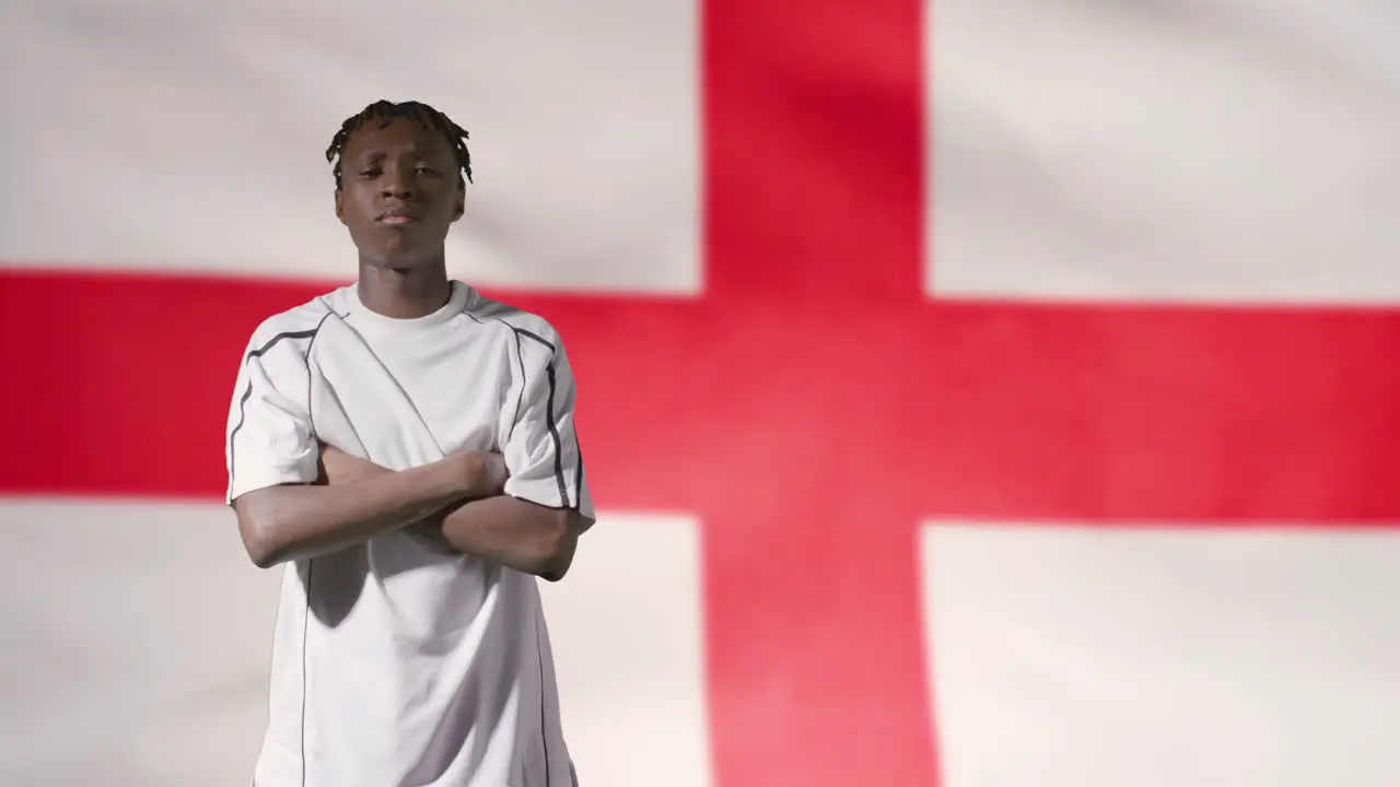 Young Footballer Walking to Camera In Front of England Flag 02