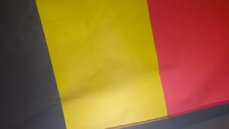 Close Up Studio Shot Of Belgian Flag Flying Filling Frame