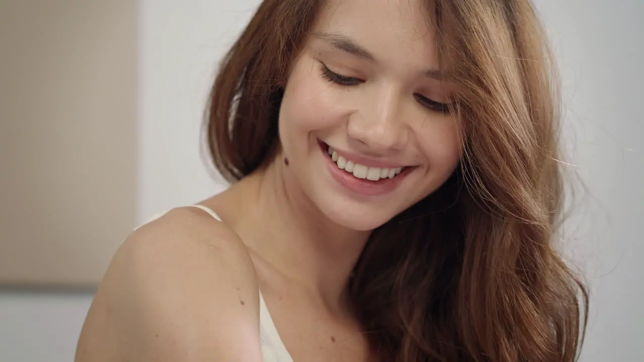 Young woman body care at morning Portrait of happy woman applying body cream