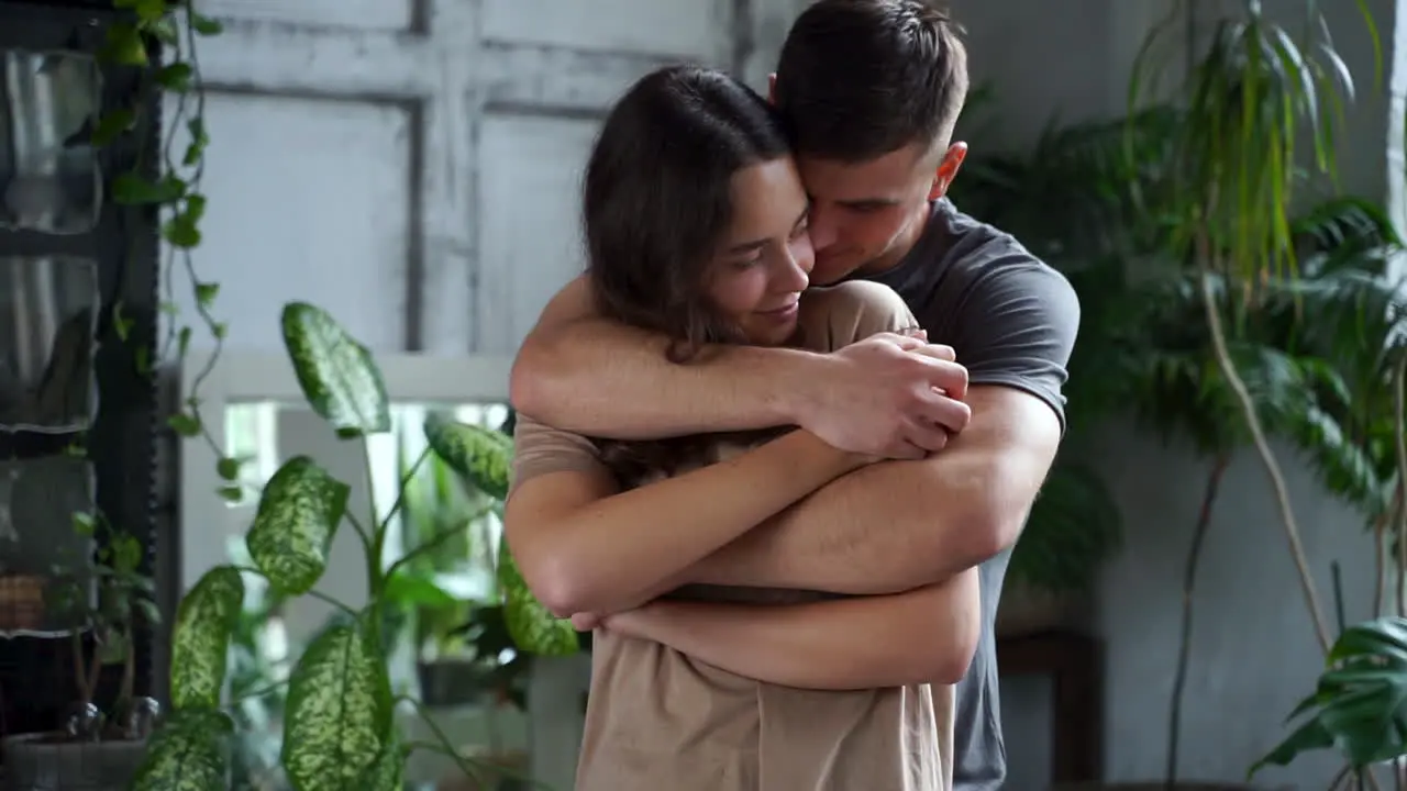 Young Man Hugging Woman From Behind