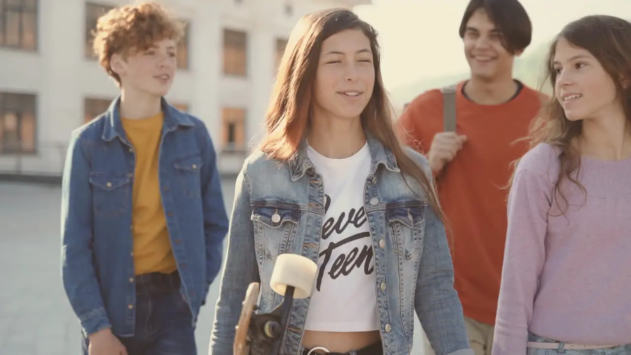 A Group Of Teenagers Walk Down The Street 1