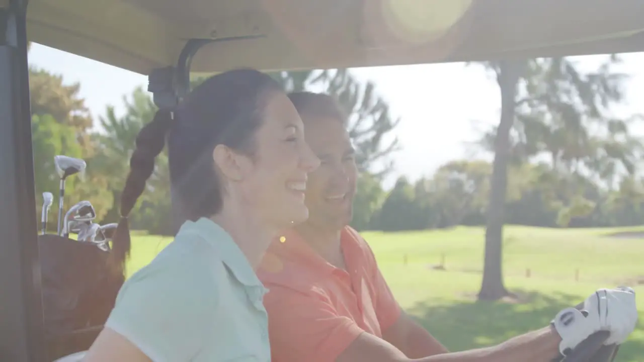 Two golfers driving in their golf buggy 