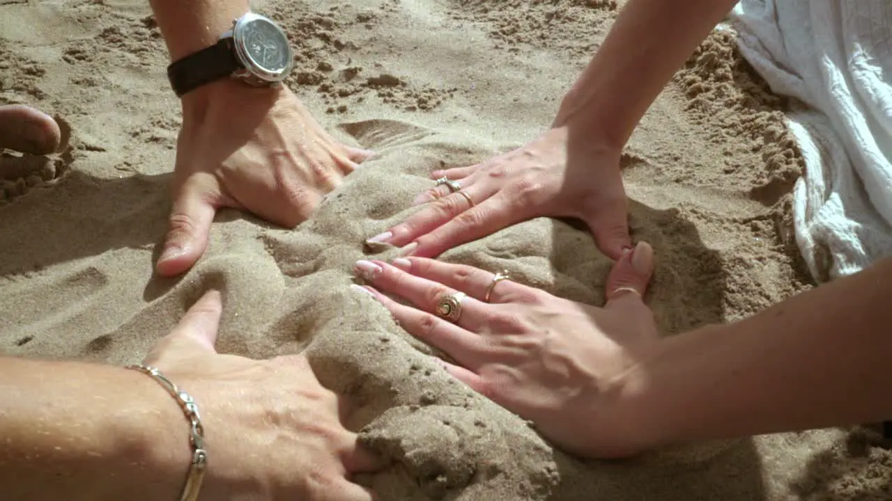 Hands forming heart Couple hands forming heart shape on sand