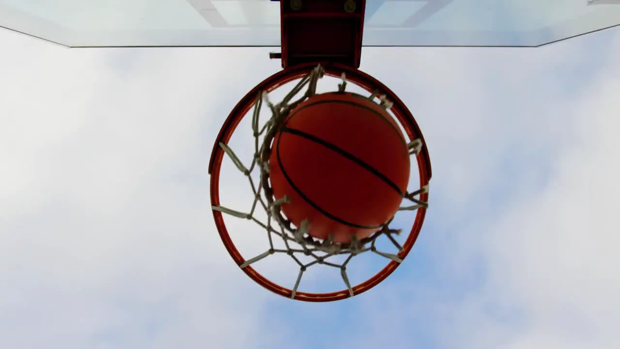 Basketball going through basketball hoop 4k