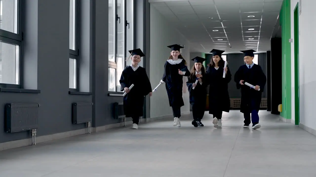 Group Of Happy Preschool Students In Mortarboard And Gown 4