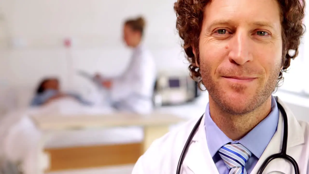 Doctor smiling at camera in the ward